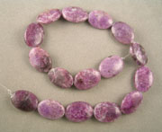 Flat oval sugilite beads.